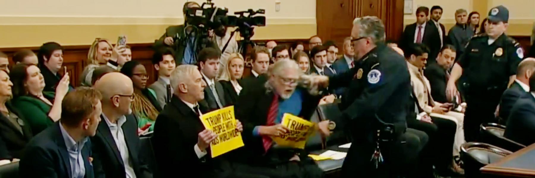 screenshot of activists being removed from U.S. House hearing room