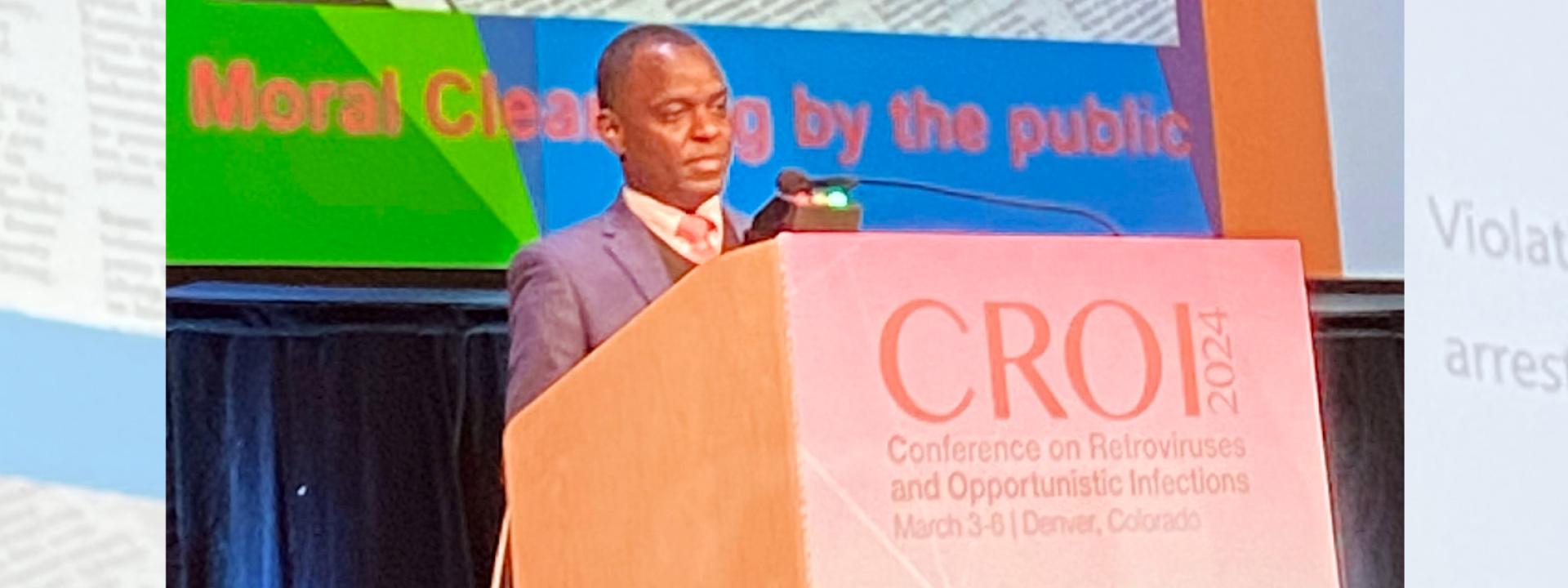 photo of Uganda gay rights activist Dr. Frank Mugashi speaking at the CROI medical conference