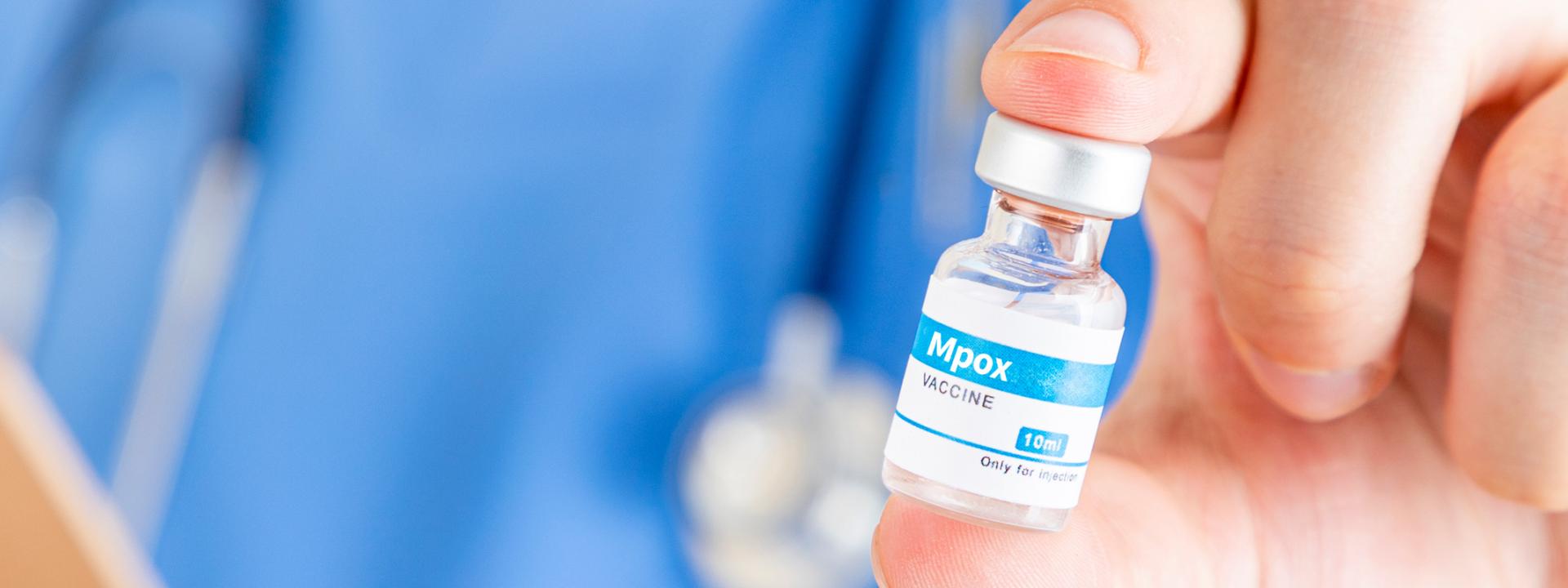 closeup of a vial of mpox vaccine, being held by a doctor