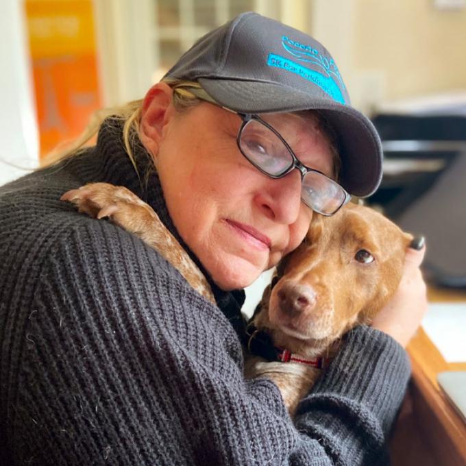 Cindy Stine hugging her dog