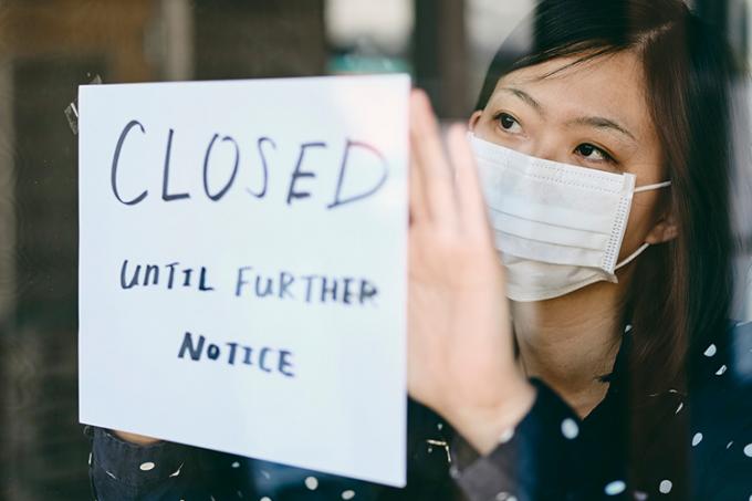 storefront window with sign that read "closed until further notice"