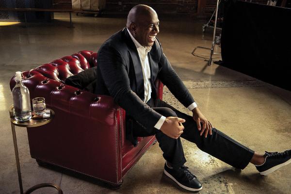 Magic Johnson seated in chair for interview