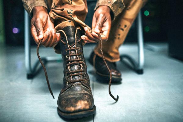 Service member tying boots