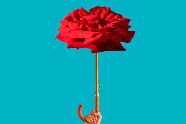 Red umbrella in the shape of flower on a red background