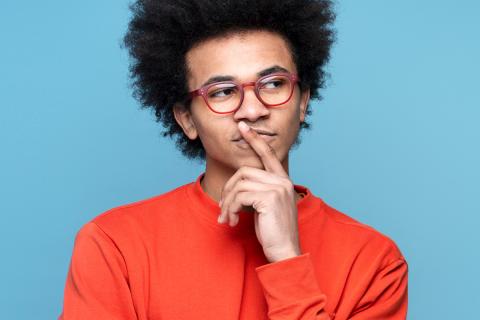 young black man looking thoughtful, contemplating his options