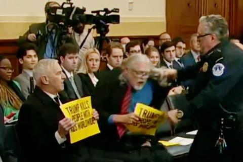 screenshot of activists being removed from U.S. House hearing room