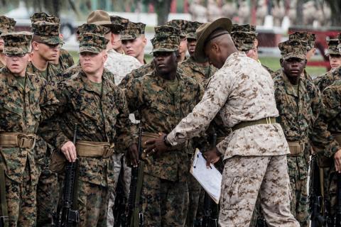 U.S. army soldiers being lined up by their commanding officer